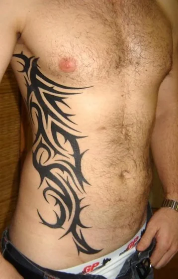Tribal pattern tattoo design for men on rib and hip tattoo ideas
