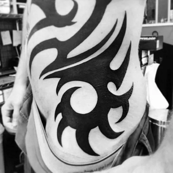 Tribal tattoo design for men on rib and hip tattoo ideas