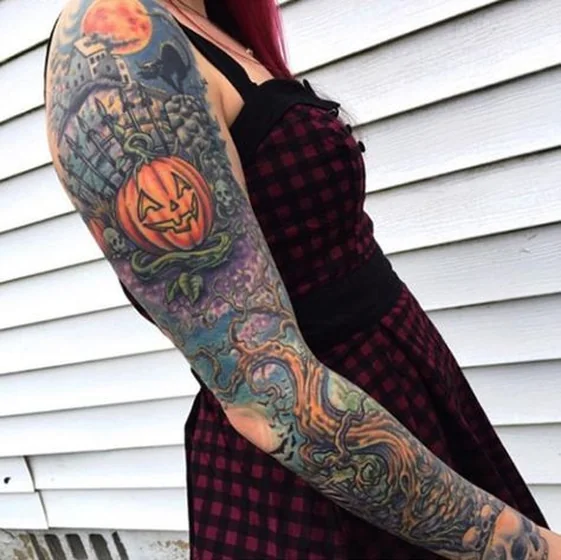 Vibrant New School Halloween full sleeve tattoo for women with skulls & moon.