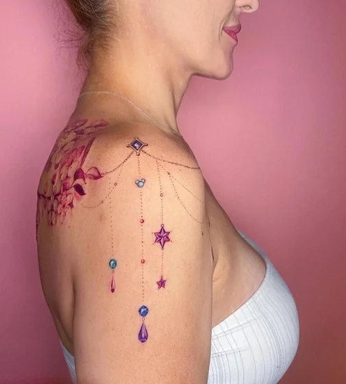 Watercolor floral, star, jewel design for women on shoulder.