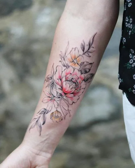 Watercolor floral tattoo design for women on forearm
