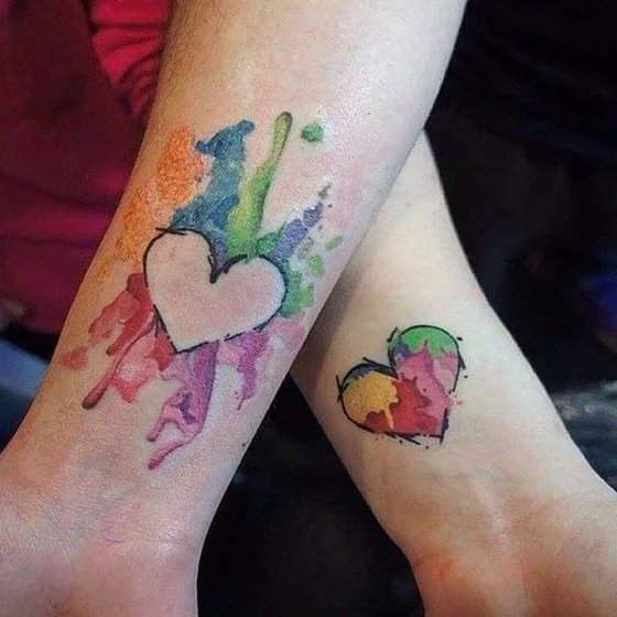 Watercolor heart tattoo design for couples on forearm and wrist