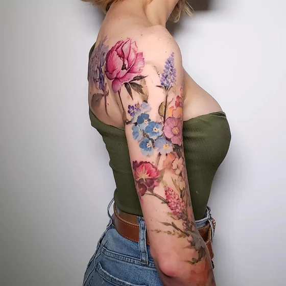 Watercolor rose floral tattoo idea for women on shoulder and arm
